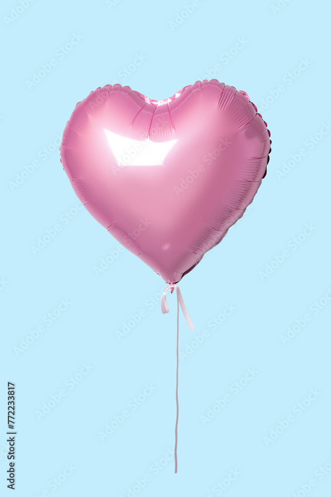 Pink heart shaped balloon on bright background. Minimal love concept.