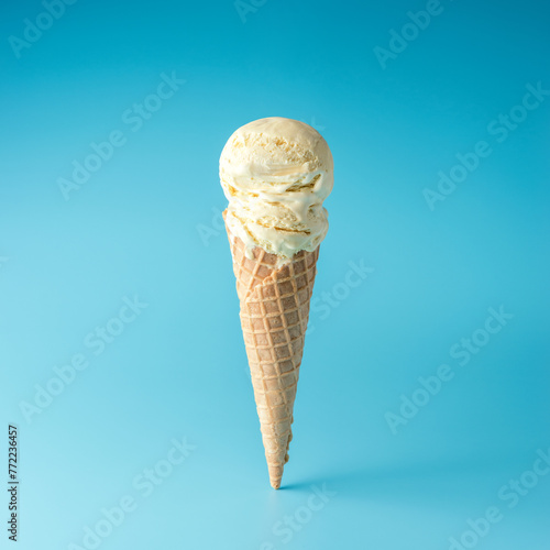 Ice cream scoop with ice cream cone on bright background. Minimal summer concept.