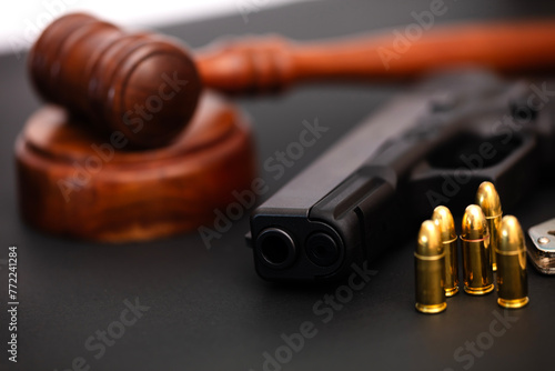 Hand gun weapon and judges gavel.