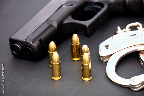 Hand gun with ammunition on dark background. 