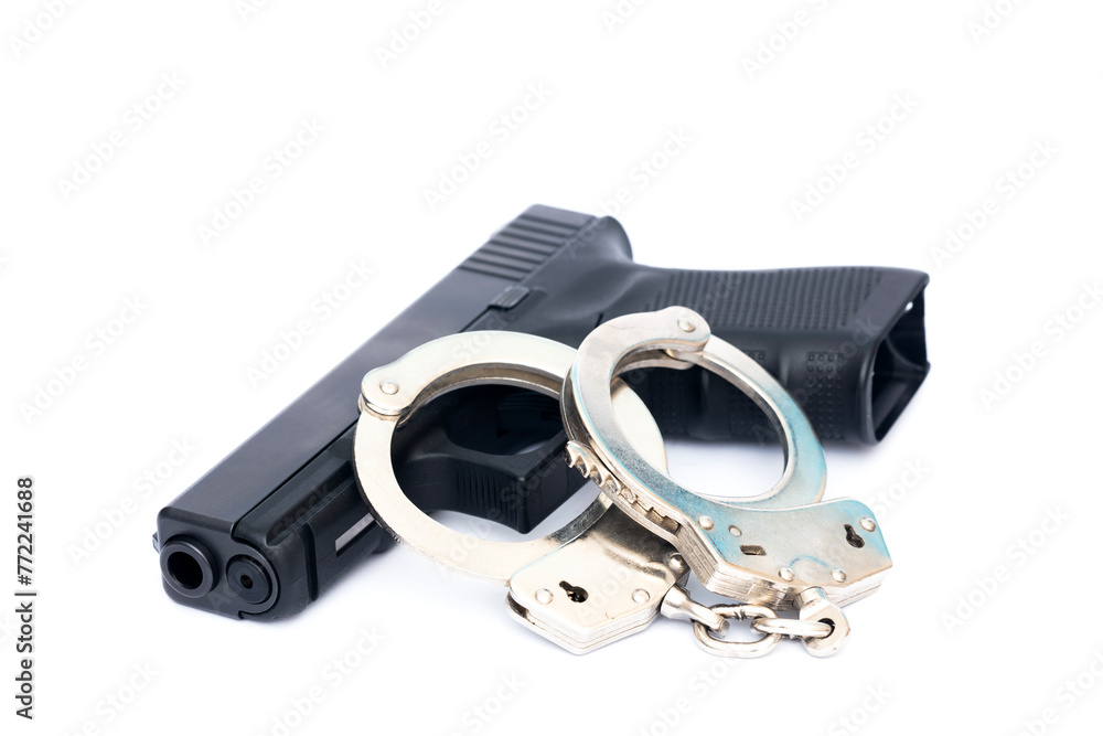 handcuff and handgun isolated on white background. handcuff and handgun isolated on white background.