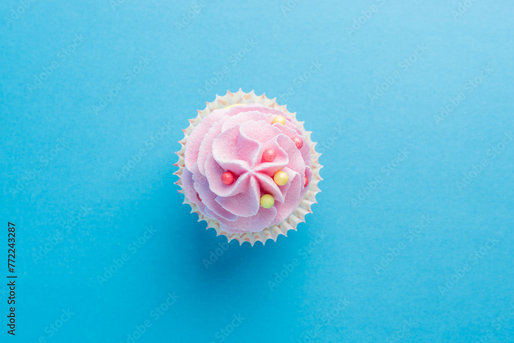 Colorful celebration background with cupcake. Minimal party concept. Top view. Colorful celebration background with cupcake. Minimal party concept. Top view.