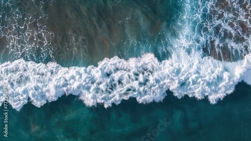 Aerial view of ocean waves crashing near the shore - Crisp bird's eye image of rolling ocean waves, capturing the powerful natural beauty of the sea