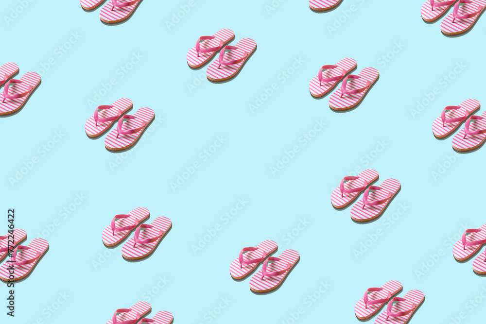 Creative pattern with beach slippers on blue background. Minimal summer concept. Creative pattern with beach slippers on blue background. Minimal summer concept.