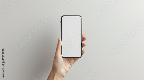 Close up of woman hand holding modern smart phone mockup. New modern black frameless smartphone mockup with blank white screen. Isolated on white background high quality studio shot Modern smart.