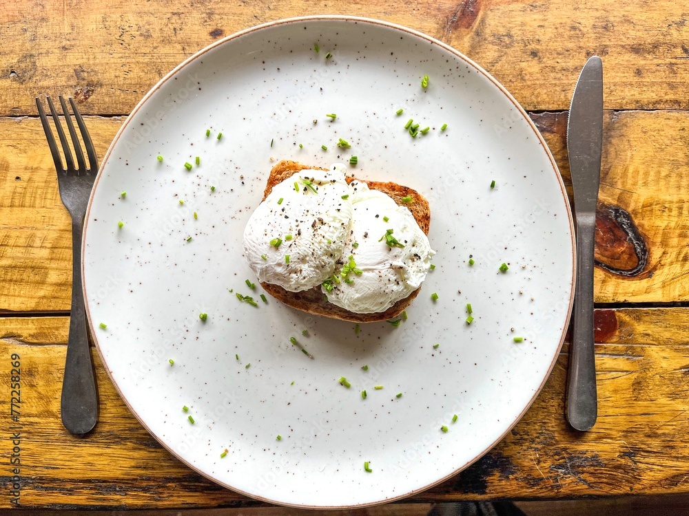 two poached eggs on a white plate from bits eye view two poached eggs on a white plate from bits eye view