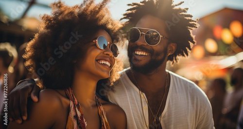 Joyful harmonies. A young man and woman, glowing with happiness, share a moment of joy as they smile brightly at the camera at a rock or electronic music festival during sunrise photo