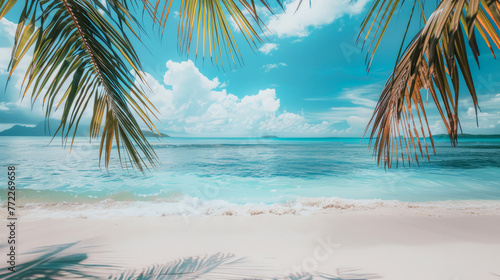 Idyllic tropical beach panorama with vibrant sky, palm leaves, and tranquil azure ocean