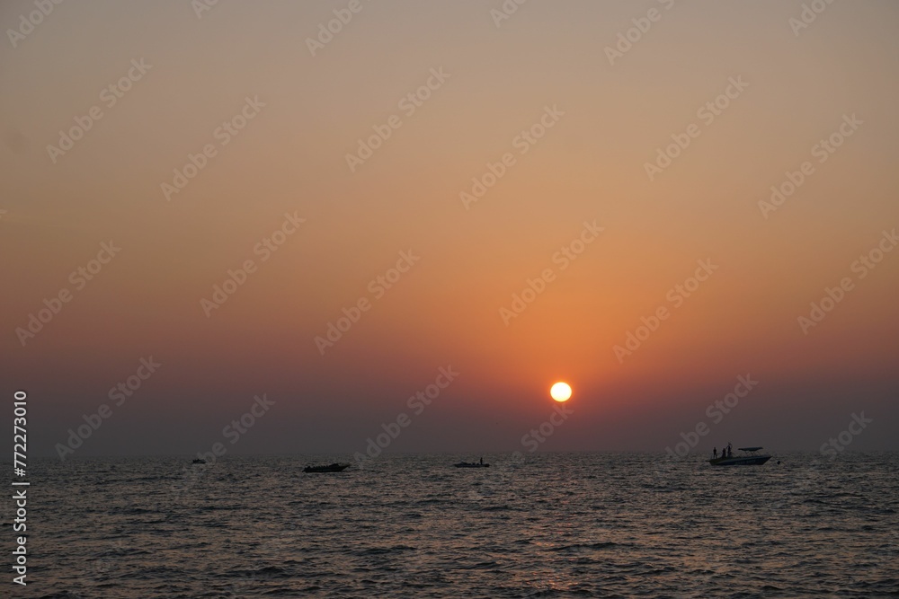 the sun is setting over the ocean as seen from the pier the sun is setting over the ocean as seen from the pier