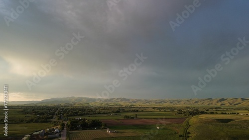 Aerial view of an arid farmland landscape under a cloudy sky. photo