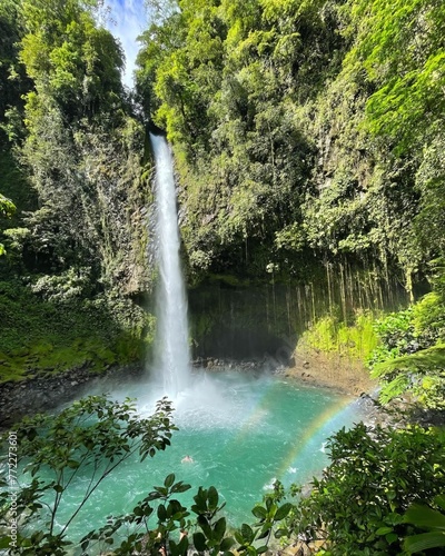 Beautiful and tranquil landscape featuring a waterfall cascading from a cliff