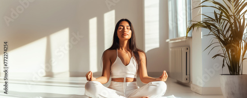 Young Woman in Lotus Pose Meditating Indoors 