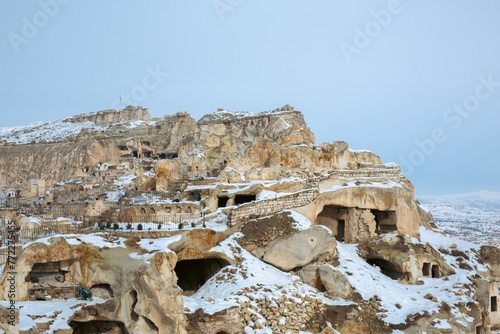 Beautiful shot of the fairy chimneys and the Goreme Open Air Museum in Cappadocia on a snowy day photo