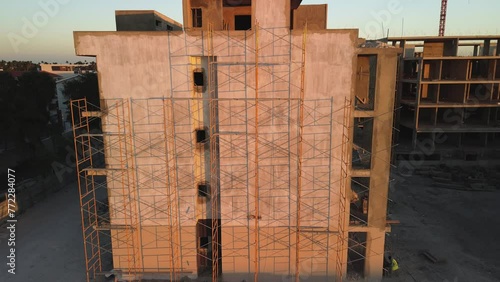 Aerial view of an modern apartment building under construction. Scaffolding at sunset. Dominican Republic. Punta Cana. Noval. photo