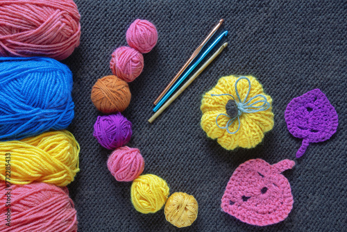 Knitting concept. Colorful balls of wool,  crochet hooks and knitted pumpkin