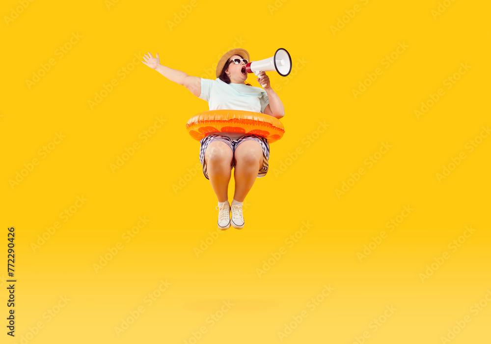 Full body photo of a happy funny fat plus size overweight woman in sunglasses with rubber ring jumping and speak in mouthpiece on studio yellow background. Summer holiday trip and vacation concept. - obrazy, fototapety, plakaty 