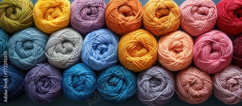 Various colorful balls of yarn neatly organized next to each other with space between rows.