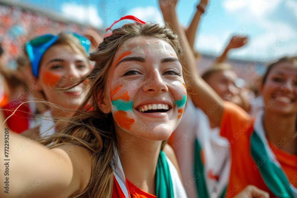 Young woman with colorful face paint celebrating at a sports event, radiating joy and team pride
