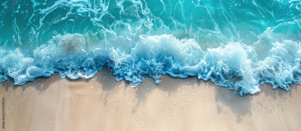 An aerial perspective of a beach with vibrant blue water, showcasing the beauty of the ocean meeting the sandy shoreline. An aerial perspective of a beach with vibrant blue water, showcasing the beauty of the ocean meeting the sandy shoreline.