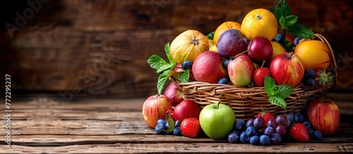 A basket brimming with various types of fresh fruits, showcasing a colorful assortment against a rustic backdrop.
