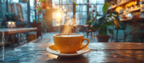 An aromatic cup of hot coffee steaming on a rustic wooden table. photo