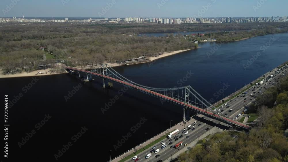 Aerial top view by drone of red-green pedestrian bridge over the Dnieper river in Kiev city. Aerial top view by drone of red-green pedestrian bridge over the Dnieper river in Kiev city.