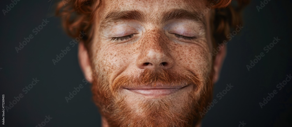 A close-up view of a man with freckles on his face, showcasing his unique features and facial expressions.