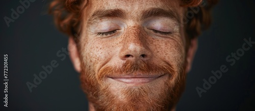 A close-up view of a man with freckles on his face, showcasing his unique features and facial expressions. photo