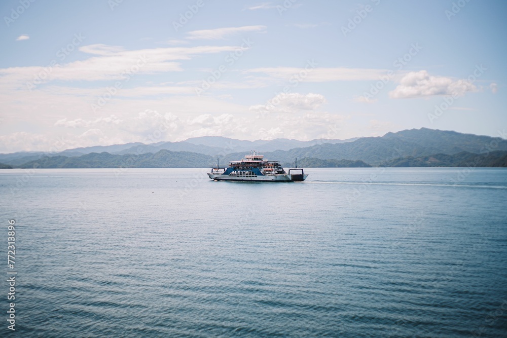 Sailboat navigating a crystal-clear blue body of water in Costa Rica