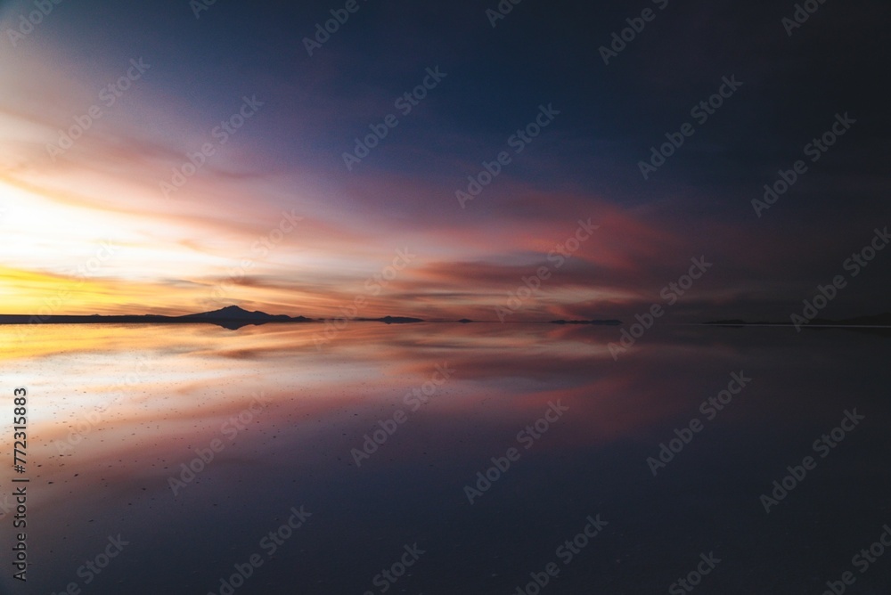 Beautiful sunset mirrored in the tranquil water surface.