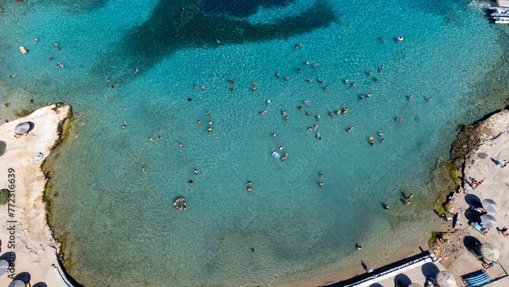 the sun is shining on an aerial view of a pool and beach