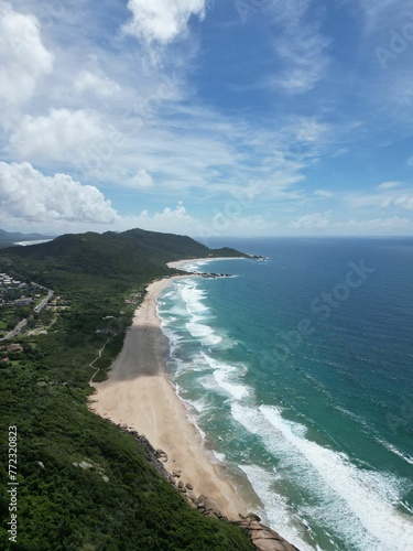 Aerial view of soft ocean waves on a sandy beach