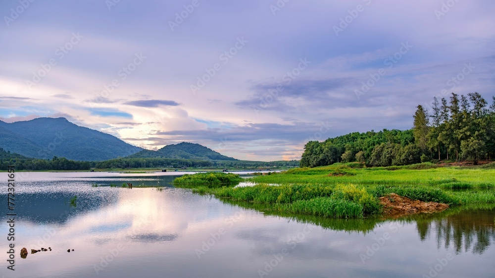 Idyllic landscape of a tranquil river with mountains in the background Idyllic landscape of a tranquil river with mountains in the background