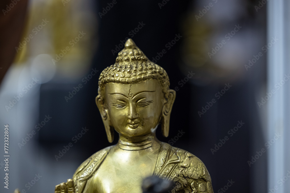 Brass metal art, Handmade Lord Buddha sculpture souvenir made with brass with blur background. Selective focus.