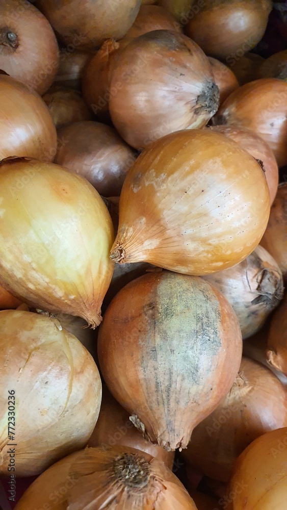 Close up pile of fresh onions placed together in local market as a background. Close up pile of fresh onions placed together in local market as a background.
