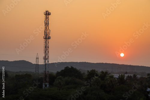 tower at sunset with a hill on background 