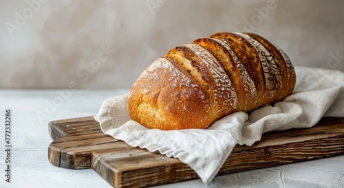 Freshly baked bread loaf with a golden crust showcased on a rustic wooden