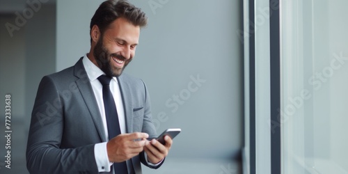 A successful smiling businessman in a suit stands against the background of a gray wall in the office. Generative AI.