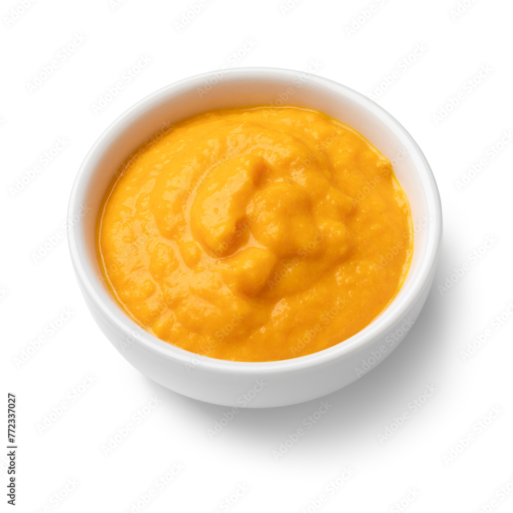 Single white bowl with Peruvian Aji Amararillo pepper sauce close up isolated on white background Single white bowl with Peruvian Aji Amararillo pepper sauce close up isolated on white background