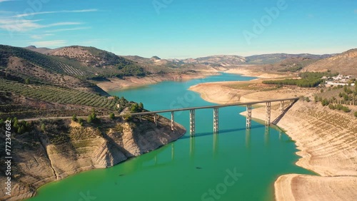 Aerial 4K video from drone to town Iznajar on a sunny summer day. Cordova, Andalusia, Spain photo