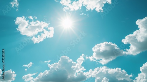 The sky is blue with a few clouds and the sun is shining brightly. The sun is the main focus of the image, and it is the brightest object in the sky