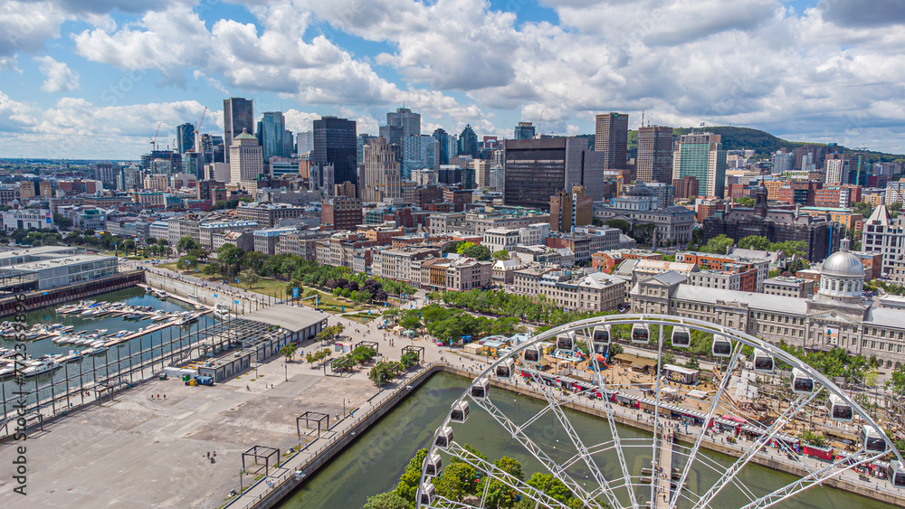Naklejka premium Aerial panoramic view of downtown Montreal financial district and the historic old port on a summer day, Mount Royal mountain in the backdrop, Quebec, Canada. Photo taken by drone in August 2021.