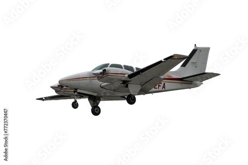 Multi Engine flying aircraft. Isolated general aviation airplane on white background. Retractable landing gear extended, twin engine propeller plane, low wing piston powerplant