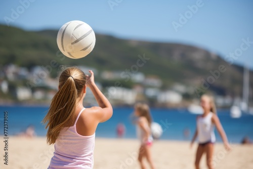 Three women playing beach volleyball under the sun on a summer day, with clear blue skies and gentle waves in the background, enjoying a friendly match on the sandy shores of a picturesque beach
