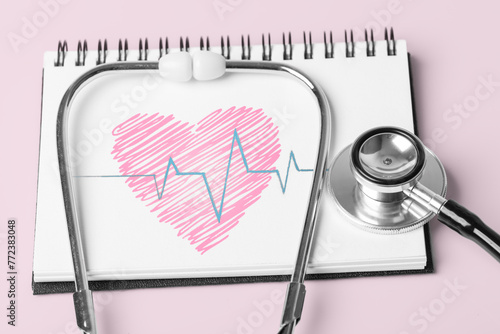 Stethoscope and Pulse Heartbeat Notebook Still Life Object on Pink Background