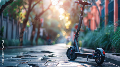 A sleek electric scooter parked, with its removable battery beside it, urban setting softly blurred photo