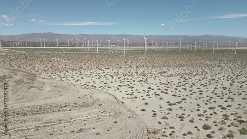 4K Aerials of the windmill farm in Palm Springs, California at the foot of the San Jacinto Mountains, adjacent to Highway 111, which helps provide energy for the Coachella Valley in Riverside County.