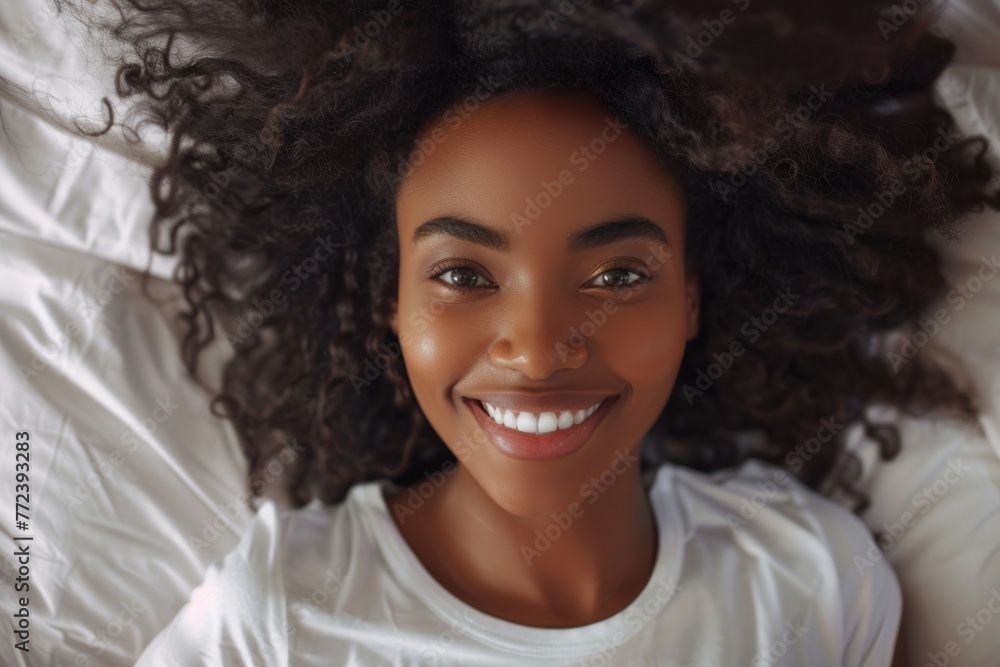 Happy smiling African beauty woman who recently woke up after a healthy and good sleep in bed - obrazy, fototapety, plakaty 