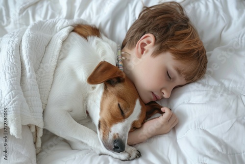 kid and dog sleeping together in white bed at home