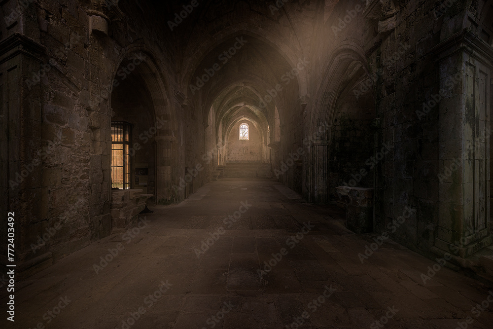 Interior of the monastery of Santa Maria de Rioseco, in Burgos, on a cold winter morning with a ray of light entering through a window